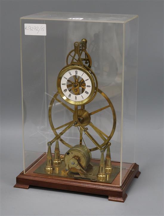 A skeleton clock, in perspex case